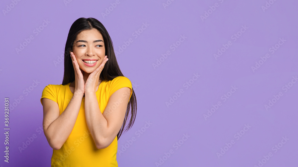 Amazing Offer. Curious Asian Girl Looking Aside And Touching Face In Excitement Amazing Offer. Curious Asian Girl Looking Aside And Touching Face In Excitement