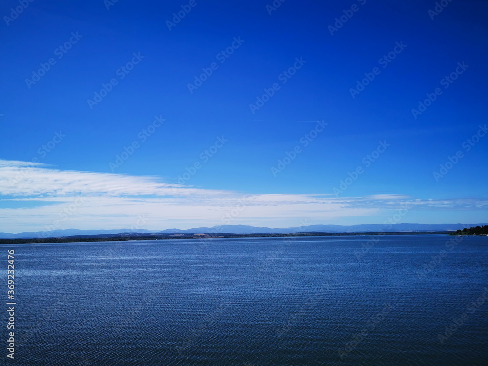 View of the Nysa lake in the background of the blue sky. View of the Nysa lake in the background of the blue sky.
