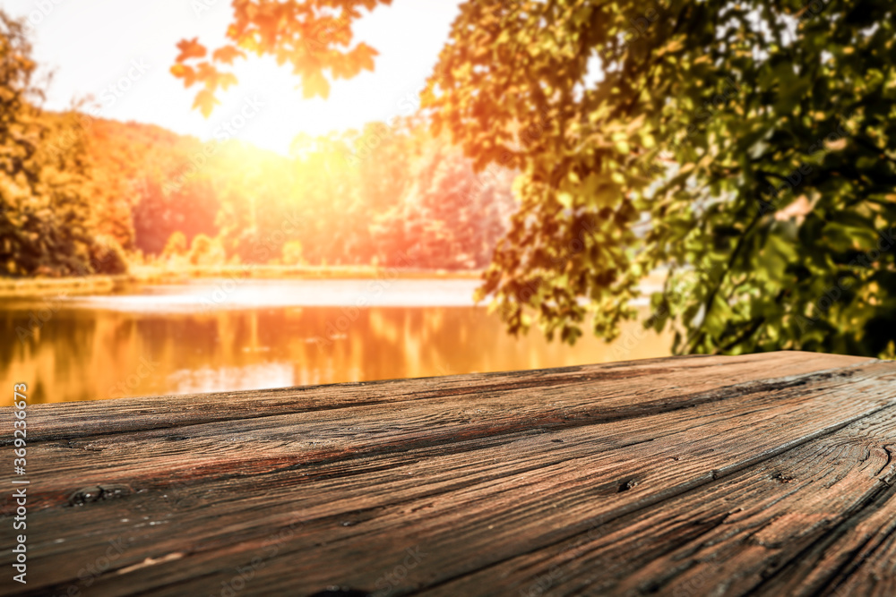 Wooden desk of free space and autumn landscape of lake Wooden desk of free space and autumn landscape of lake