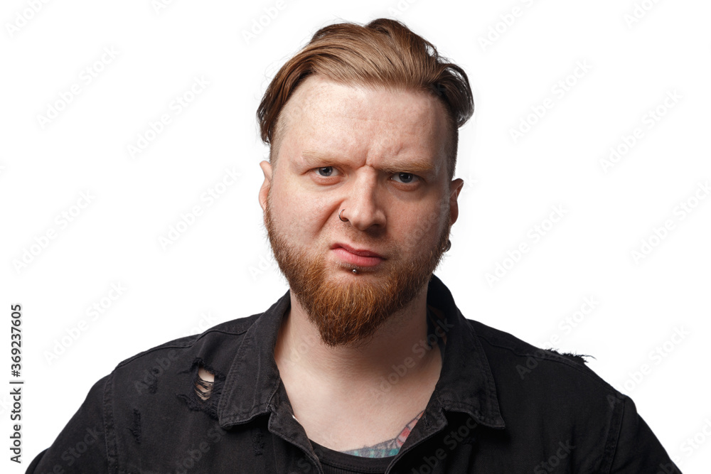 Image of bearded dissatisfied man in black jeans jacket Image of bearded dissatisfied man in black jeans jacket
