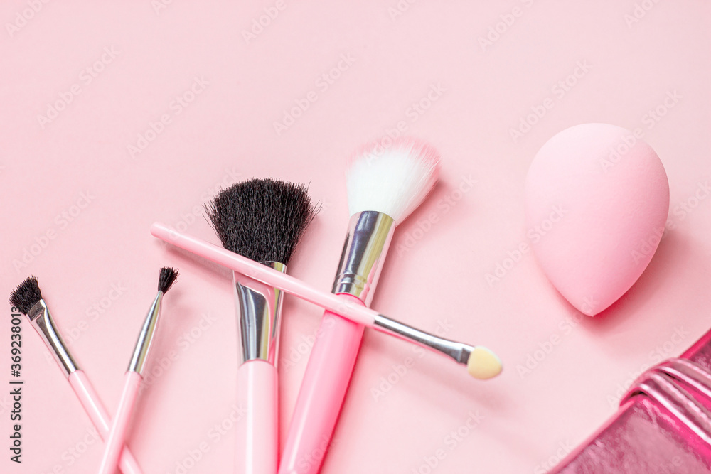 Top view of bright pink decorative cosmetics tools and accessories for professional make up and visage on light background with copy space. Top view of bright pink decorative cosmetics tools and accessories for professional make up and visage on light background with copy space.