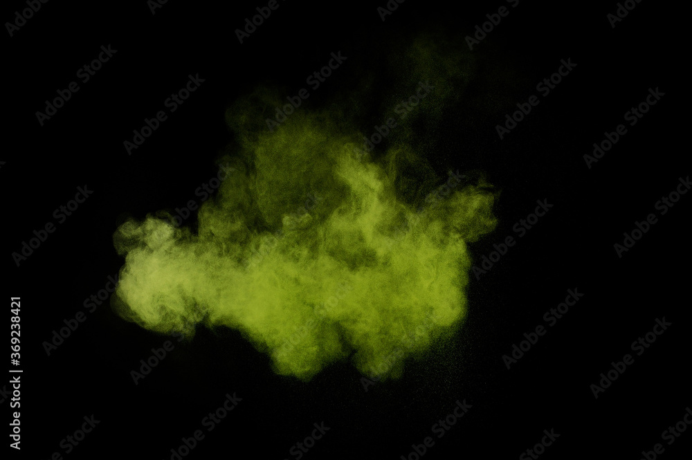 Light green powder explosion on black background. Colored powder cloud. Colorful dust explode. Paint  Holi.