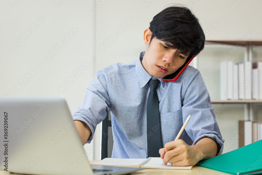 Male employee is busy with work on the desk. Male employee is busy with work on the desk.