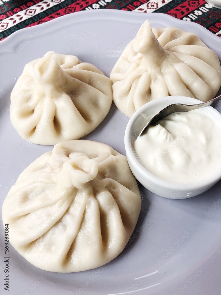 Delicious khinkali with meat and sour cream Delicious khinkali with meat and sour cream