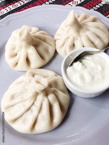 Delicious khinkali with meat and sour cream