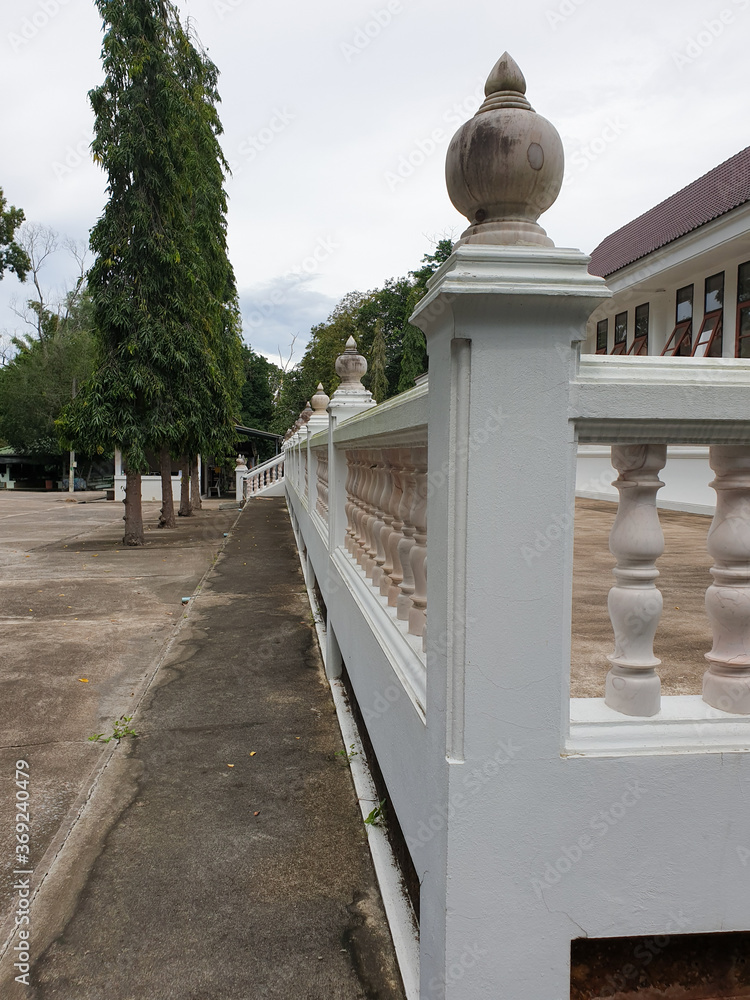 Buddhist temple's concrete balcony fence in bright sunlight