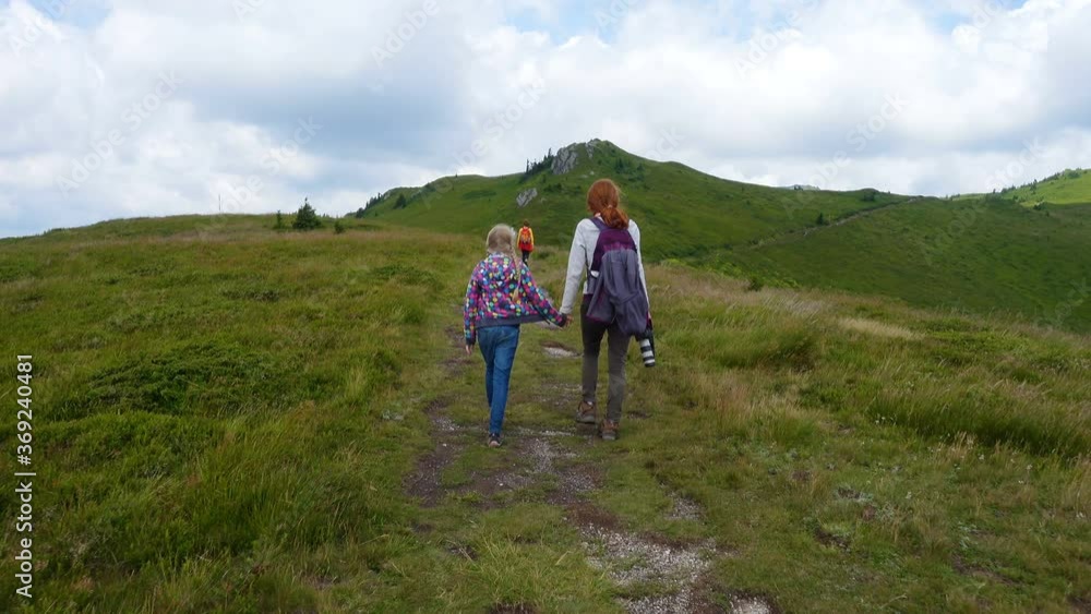 active family mother and daughters hiking at the mountains
active family mother and daughters hiking at the mountains