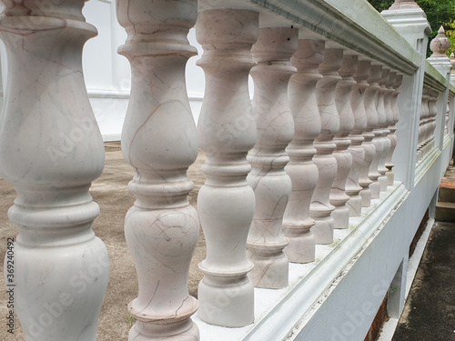 Buddhist temple's concrete balcony fence in bright sunlight