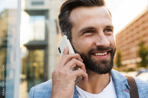 Young urban businessman on smart phone