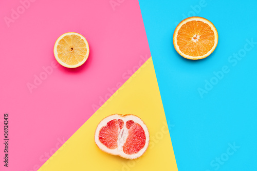 Citrus fruits on abstract geometry colored paper texture minimalism background