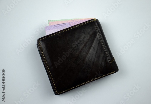 leather wallet with money on white background