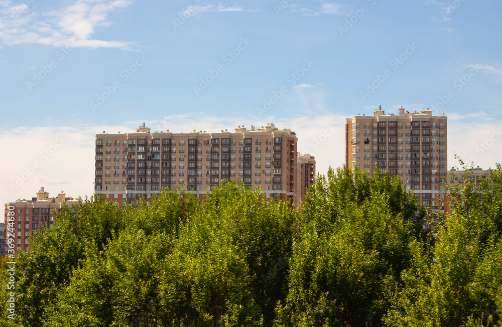 Brown concrete buildings are built in summer in St. Petersburg.