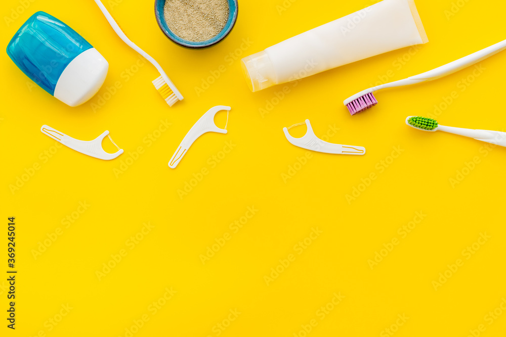 Concept of oral cleaning with toothbrushes, dental floss, tooth powder. Top view Concept of oral cleaning with toothbrushes, dental floss, tooth powder. Top view