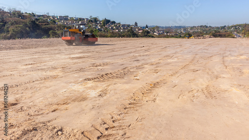 Wallpaper Mural Industrial Development Site Construction Earthworks Grader Roller Machine leveling sand soil platform in rural countryside landscape a panoramic photo. Torontodigital.ca