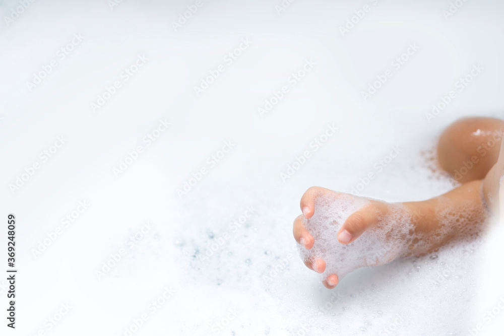 Fototapeta premium baby hands playing with bubble while bathing
