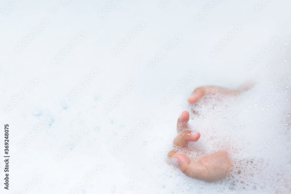 Fototapeta premium baby hands playing with bubble while bathing