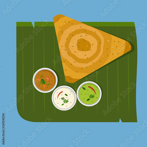 Indian breakfast dish 'Dosa with Sambar and Chutney' on banana leaf 