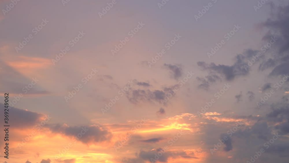 Beautiful evening blue sky at sunset with flaming bright light clouds. A warm summer evening at sunset. Bright sunset. Beautiful evening blue sky at sunset with flaming bright light clouds. A warm summer evening at sunset. Bright sunset.