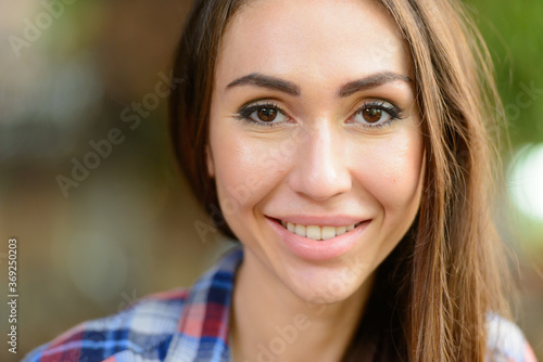 Young beautiful hipster woman at the coffee shop outdoors