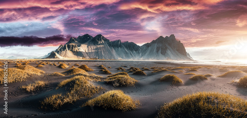 Impressive view of Vestrahorn mountaine on Stokksnes cape in Iceland during sunset. Amazing Iceland nature seascape. popular tourist attraction. Best famouse travel locations. Scenic Image of Iceland photo