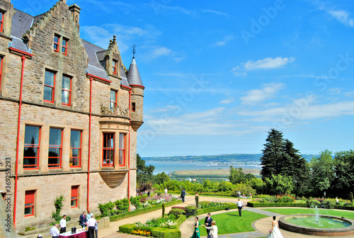 View from Belfast Castle, Northern Ireland, surrounded by a garden with people and in the background Belfast Lough.