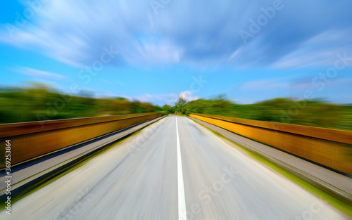 Driving on the road, motion blur effect. Empty asphalt road in motion blur