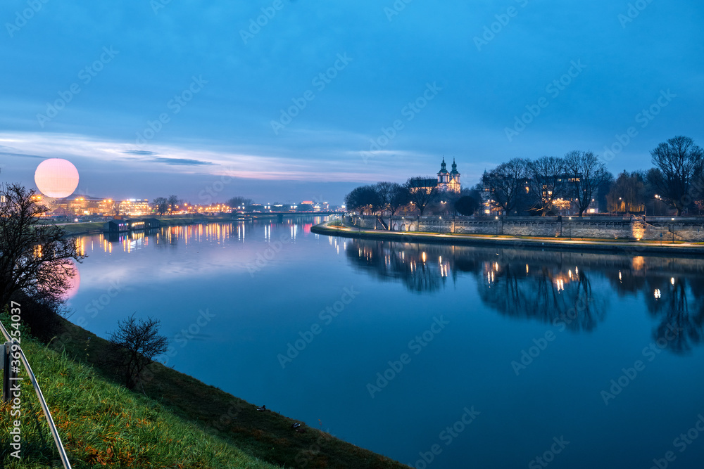 View of the  Vistula River at night in Krakow, Poland.