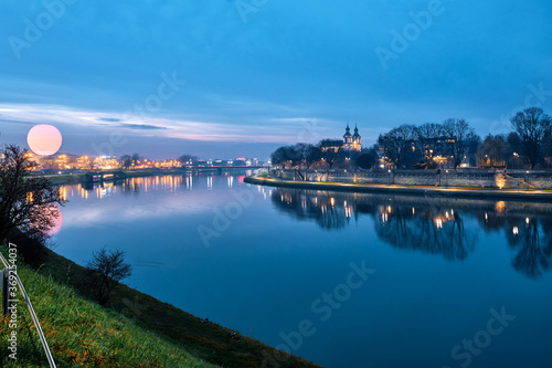 View of the Vistula River at night in Krakow, Poland.