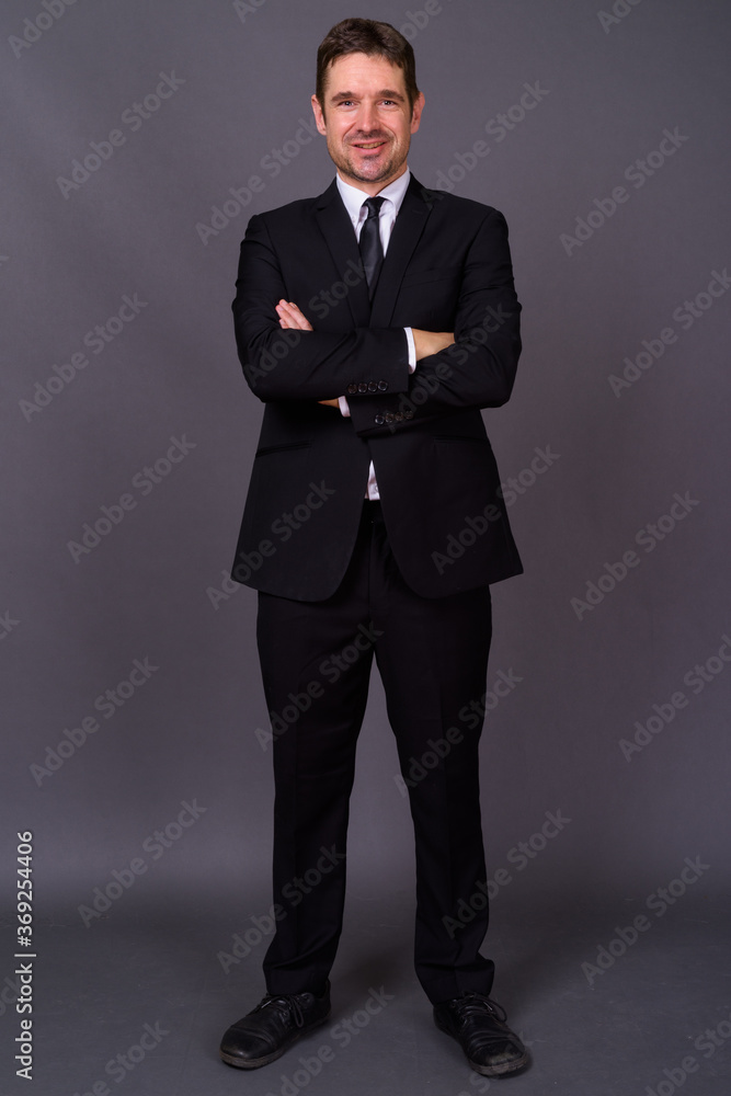 Portrait of happy handsome bearded businessman in suit Portrait of happy handsome bearded businessman in suit