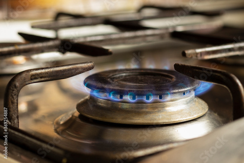 Lit gas burner on the kitchen stove.