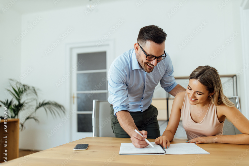 Tutor explaining something to a female university student, portrait. Tutor explaining something to a female university student, portrait.