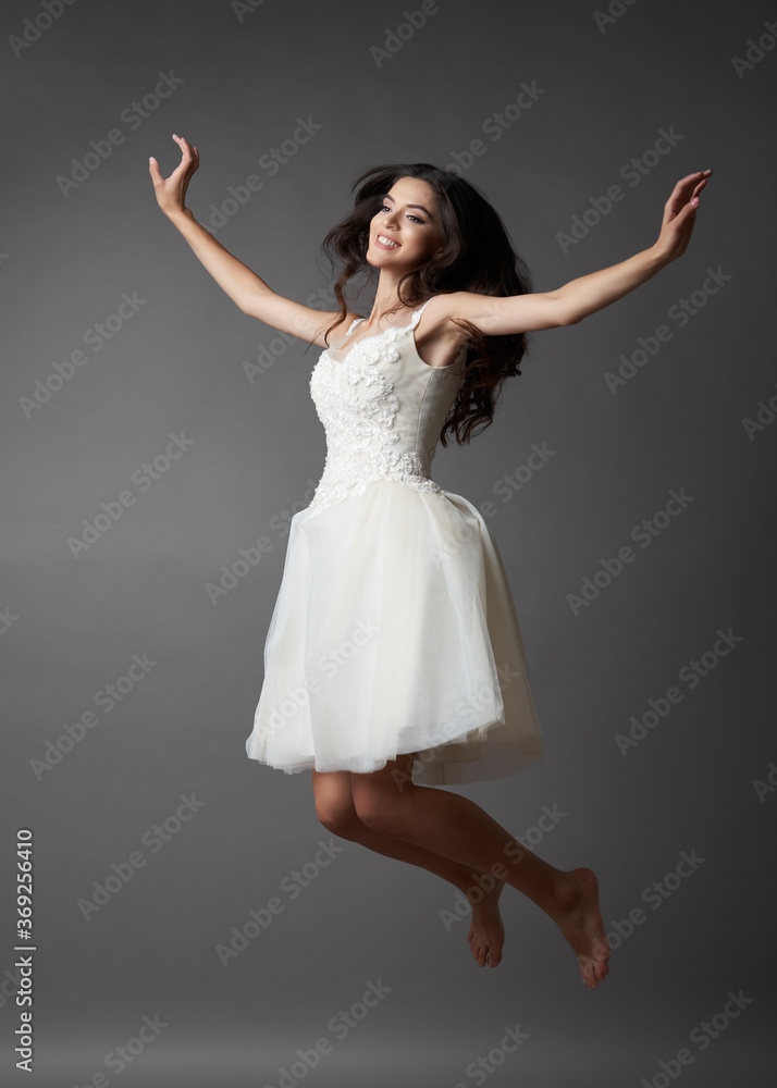 Naklejka premium Beautiful bride on gray background. Portrait of a Bride in beautiful wedding dress.