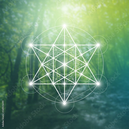 Merkaba sacred geometry spiritual new age futuristic illustration with interlocking circles, triangles and glowing particles in front of blurry natural photographic background
