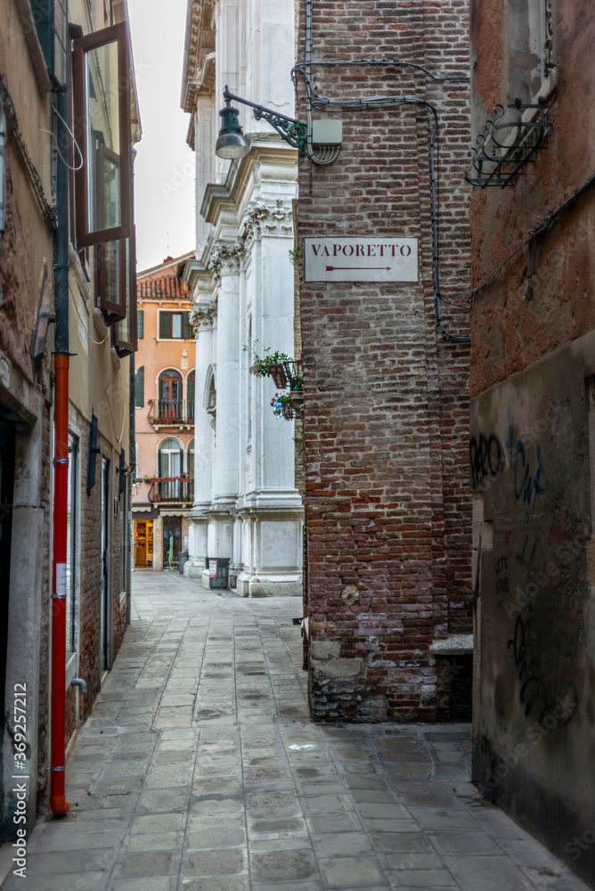 The light and shadows in the empty narrow alleys of Venice  during the coronavirus (with the direction to the WaterTaxi, 
