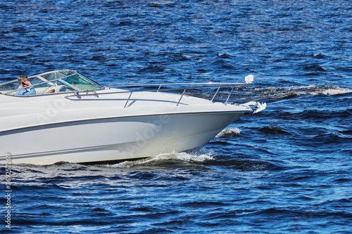 Modern fashionable speed boat sails in the sea. © gesrey