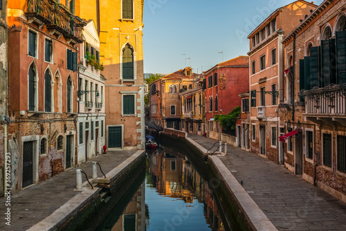 View of the  water channels, bridges and old palaces in Venice at sunrise during the lockdown © gdefilip