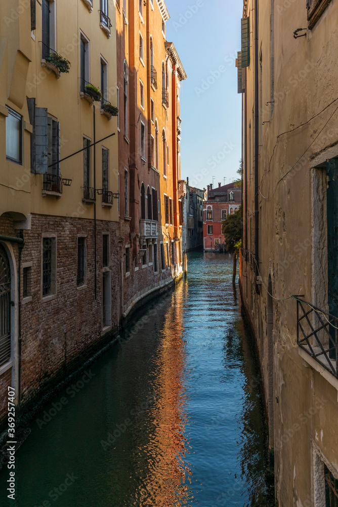 View of the  water channels, bridges and old palaces in Venice at sunset