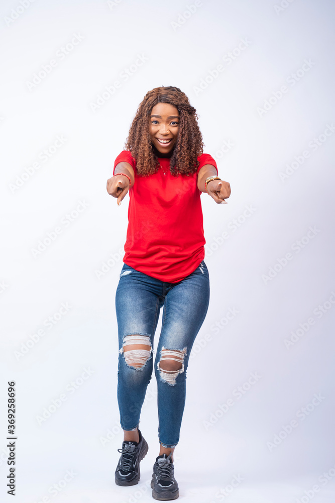 excited and happy young black lady pointing forward toward the viewers excited and happy young black lady pointing forward toward the viewers