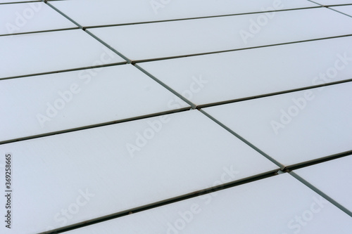 office building wall with white plastic decorative tiles