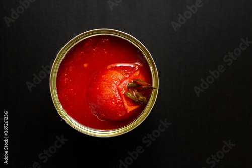 Принти на полотні Opened tin can of tomato sauce with one whole tomato on top
