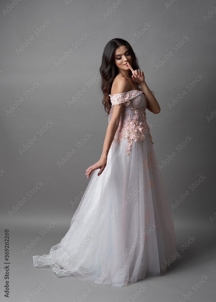 Beautiful bride on gray background. Portrait of a Bride in beautiful wedding dress. Beautiful bride on gray background. Portrait of a Bride in beautiful wedding dress.
