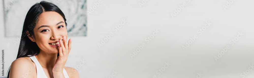 Horizontal image of beautiful asian woman smiling at camera at home Horizontal image of beautiful asian woman smiling at camera at home
