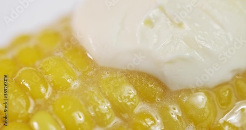 sweet farmhouse boiled corn and butter melt on it. close-up, studio shooting with macro lens