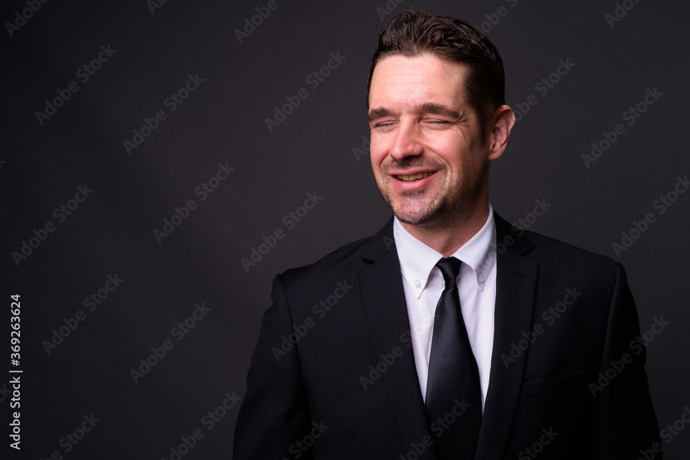 Portrait of happy handsome bearded businessman in suit Portrait of happy handsome bearded businessman in suit