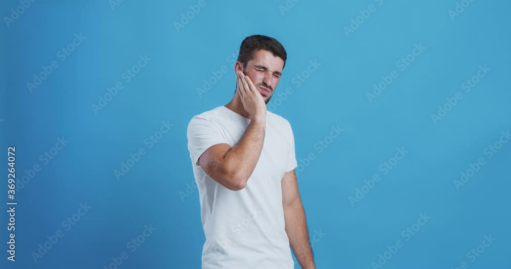 Young man suffering from acute dental pain Young man suffering from acute dental pain