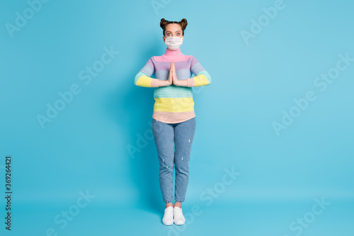 Full length photo of pretty teen lady hold hands together pleading boyfriend go shopping center wear protect face mask jeans striped pullover shoes isolated blue color background