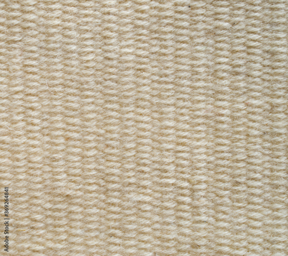 New woven ecru woolen rug close New woven ecru woolen rug close