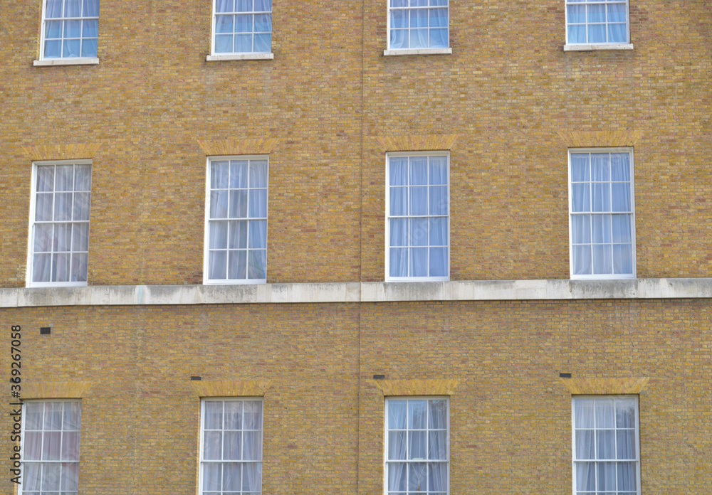 Windows on a victorian building forming a pattern