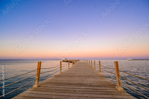 Wooden Pier on Red Sea in Hurghada at sunset and luxury yacht  View of the promenade boardwalk - Egypt  Africa