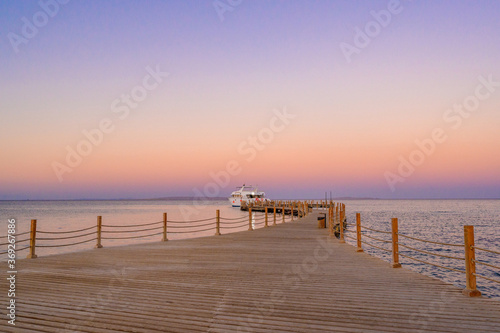 Wooden Pier on Red Sea in Hurghada at sunset and luxury yacht  View of the promenade boardwalk - Egypt  Africa